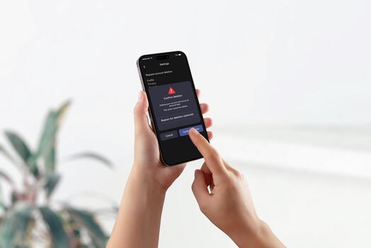Smartphone screen showing GDPR interface with warning and confirmation for account deletion, representing right to erasure and user data control. photo