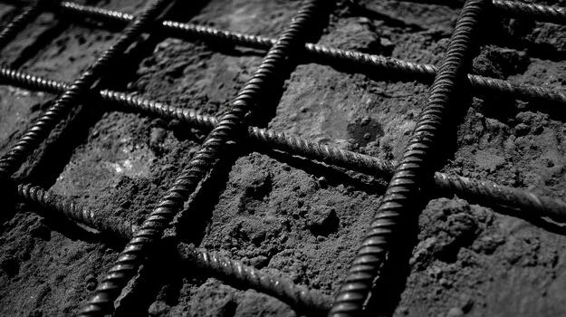 Metal Reinforcing Bars in Wet Concrete Form a Grid Pattern photo