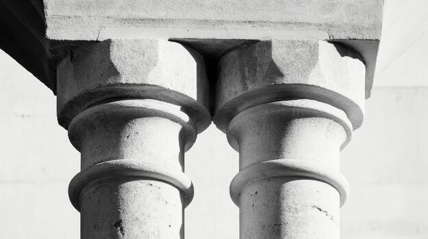 Two Architectural Stone Columns With Capitals Support a Structure on a Sunny Day photo