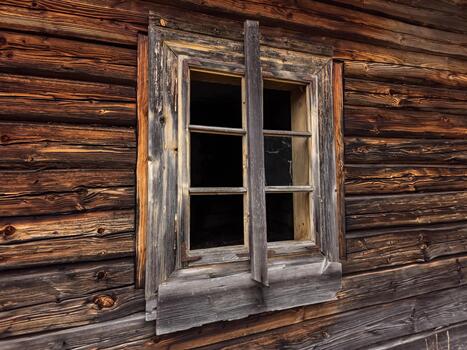 Old wooden window in a log cabin photo