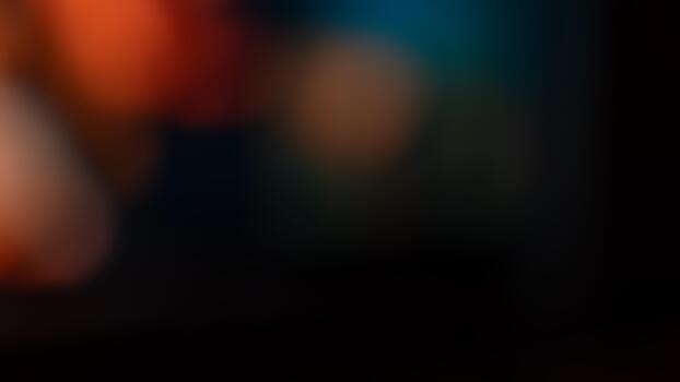 Soft blurred abstract background featuring a mix of warm orange and cool blue tones. Smooth gradient and defocused light create a moody atmosphere perfect for design, texture, or artistic projects. photo