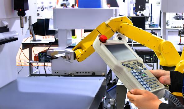 Engineer control automation Robot arm machine for assembling engines in factories photo