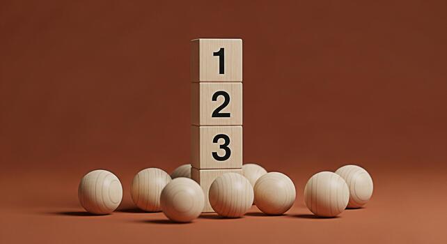 Wooden blocks displaying numbers stacked high on a brown surface surrounded by wooden balls representing a countdown sequence or priority in a minimalist and clean studio setting conveying simplicity photo