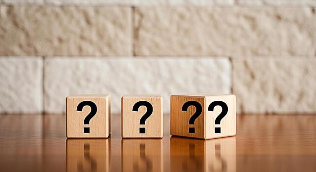 Three wooden blocks displaying question marks on a polished wooden surface against a textured brick wall symbolizing uncertainty inquiry and the search for answers in a thoughtprovoking composition photo