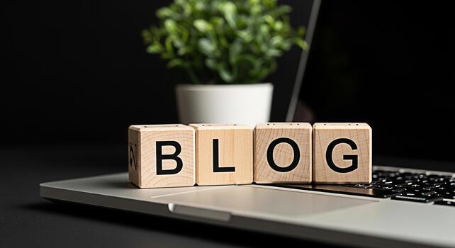 Wooden blocks spelling BLOG resting on a laptop in a modern office symbolizing online communication and content creation fostering a creative and informative atmosphere for digital marketing and blogg photo