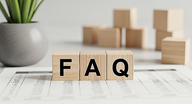 Wooden blocks spelling FAQ on a financial report in a bright office setting representing frequently asked questions and providing answers with clarity and helpful information for customer support photo