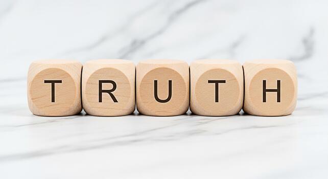 Wooden blocks spelling TRUTH on a marble surface symbolizing honesty and integrity in a clean minimalist setting conveying a message of transparency and ethical values photo