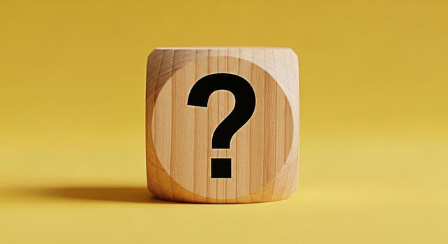 Wooden cube displaying a question mark on a yellow background representing uncertainty and the need for answers creating a sense of curiosity and intrigue about the unknown photo