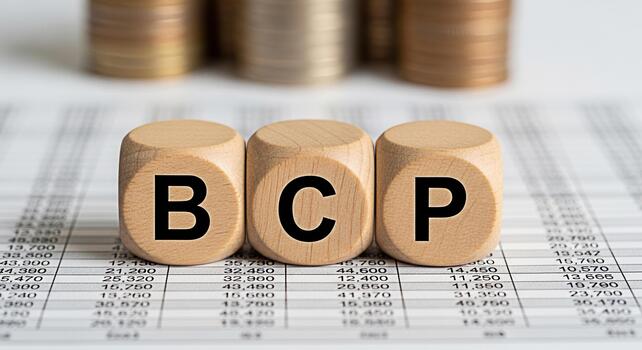 Wooden blocks spelling BCP resting on a financial document symbolizing business continuity planning and risk management in a corporate environment promoting stability and resilience photo