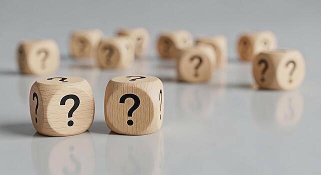 Wooden dice displaying question marks on a reflective surface symbolizing uncertainty and the search for answers in a complex world creating a mood of curiosity and intellectual exploration photo