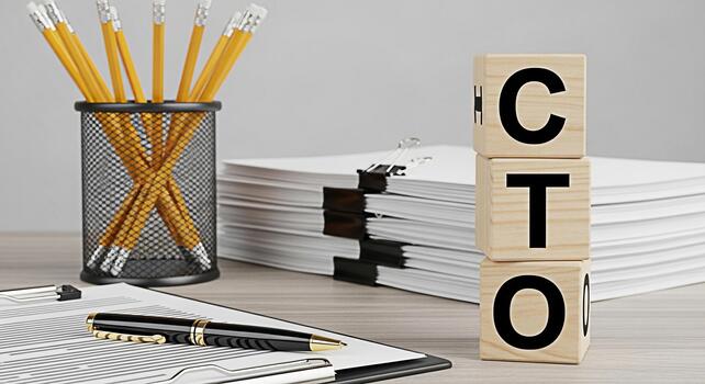 Closeup of wooden blocks spelling CTO on a desk with documents and a pen representing the Chief Technology Officers role in overseeing technological growth and innovation in a corporate environment photo