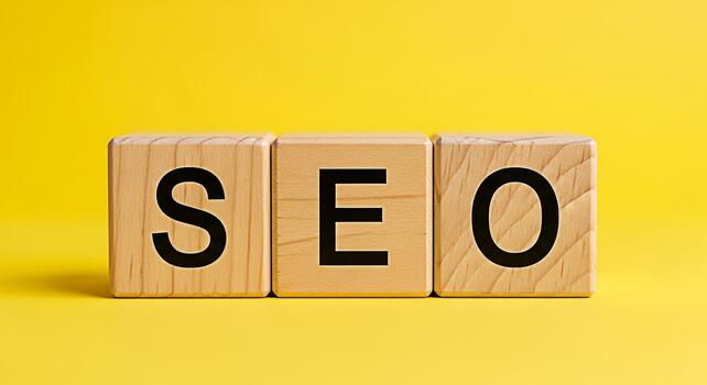 Wooden blocks spelling SEO on a bright yellow background representing search engine optimization strategies and digital marketing success conveying a positive and informative message photo