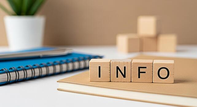 Wooden blocks spelling INFO resting on a notebook in a bright modern office setting conveying a sense of knowledge learning and access to important information for business and education purposes photo