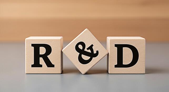 Wooden blocks displaying RD on a gray surface symbolizing research and development innovation and strategic planning in a corporate environment conveying a message of progress and growth photo