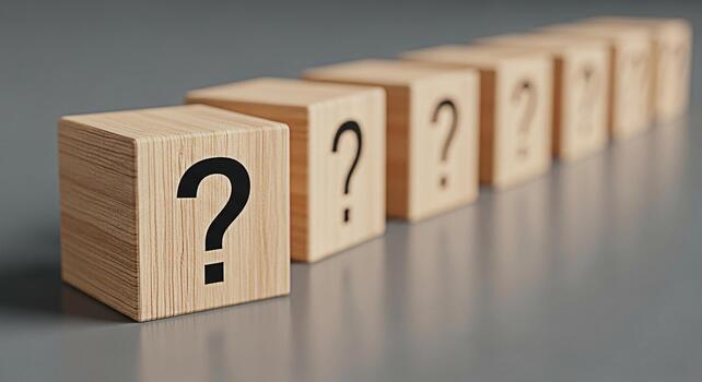 Row of wooden blocks displaying question marks on a gray surface symbolizing uncertainty and the need for answers in business education and personal development creating a sense of curiosity and inqui photo