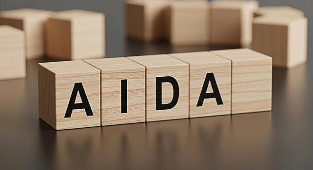 Wooden blocks displaying the AIDA model on a reflective surface representing marketing strategy and consumer behavior in a business setting conveying a message of awareness interest desire and action photo