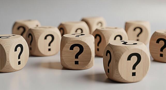 Wooden dice displaying question marks on a white surface symbolizing uncertainty and the search for answers in a minimalist and thoughtprovoking composition ideal for business and education concepts photo