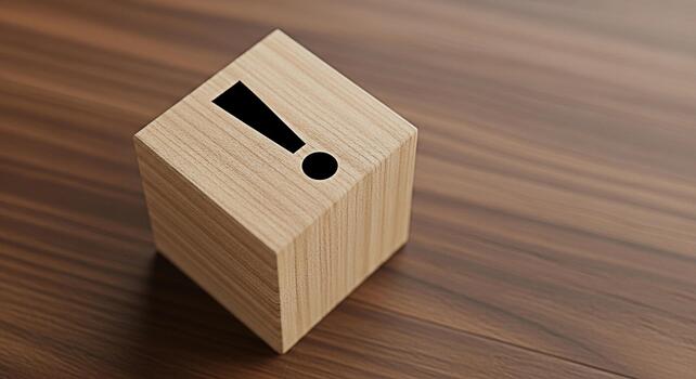 Wooden cube displaying a black exclamation mark on a brown wooden surface symbolizing urgency and attention to detail in a minimalist and modern setting conveying a sense of importance and warning photo