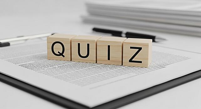 Wooden blocks spelling QUIZ resting on a clipboard with a document in a bright clean office environment representing a test challenge or assessment with a focus on knowledge and learning photo