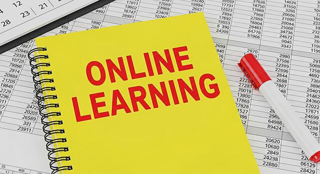 Yellow notepad displaying Online Learning on a spreadsheet background with a red marker symbolizing educational resources elearning opportunities and the concept of accessible knowledge photo