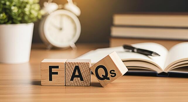 Wooden blocks spelling FAQs on a wooden desk with an open notebook and pen creating a learning environment and suggesting frequently asked questions knowledge base and customer support resources photo