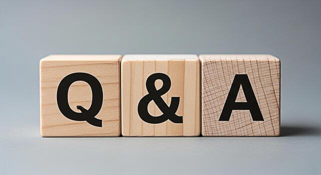Wooden blocks displaying QA on a gray surface representing questions and answers seeking information and providing solutions in a simple and straightforward manner for clarity and understanding photo