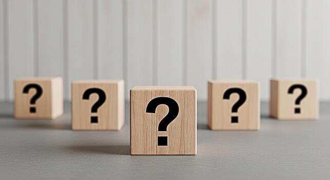 Wooden blocks displaying question marks on a gray surface against a striped wall representing uncertainty inquiry and the search for answers in a minimalist and thoughtprovoking composition photo