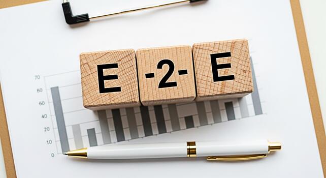 Wooden blocks spelling E2E on a clipboard with a graph representing endtoend process management and business strategy for streamlined operations and efficient workflow in a corporate environment photo