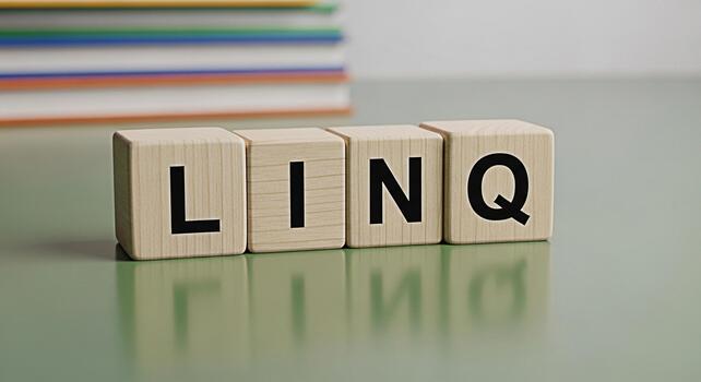 Wooden blocks spelling LINQ on a green surface reflecting light with books in the background representing a concept of technology data querying and integration in a clean and modern setting photo