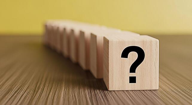 Wooden blocks displaying a question mark symbol on a wooden surface symbolizing uncertainty and the search for answers in a conceptual and minimalist setting creating a sense of curiosity and problems photo