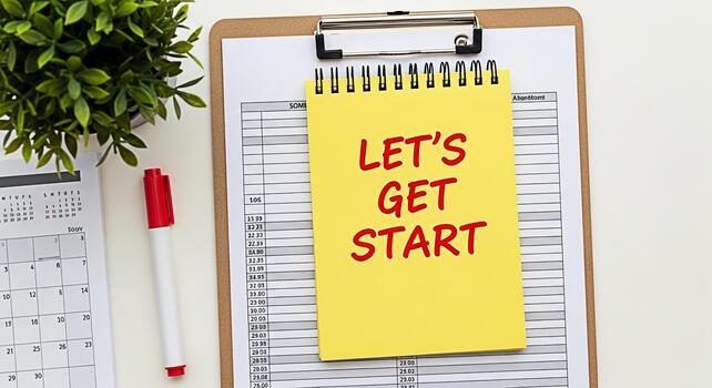 Motivational workspace setup with a yellow notepad on a clipboard displaying Lets Get Start text surrounded by a calendar pen and plant creating an inspiring and productive atmosphere for planning and photo