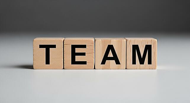 Wooden blocks spelling TEAM on a white surface symbolizing collaboration and unity in a corporate environment fostering a sense of teamwork and shared success for business growth and achieving common photo