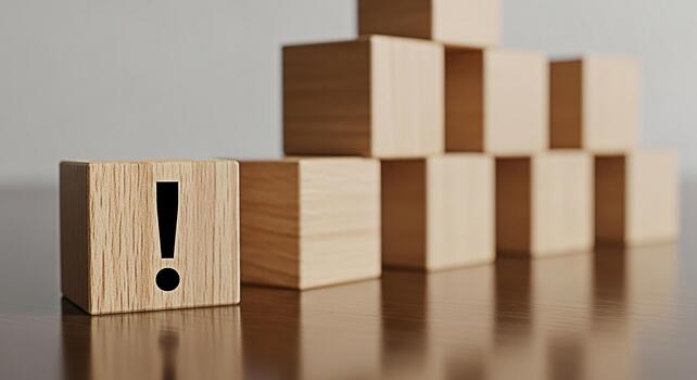 Wooden block with an exclamation mark standing out in a pyramid formation on a polished table symbolizing warning attention and the importance of problemsolving in a clean minimalist environment photo