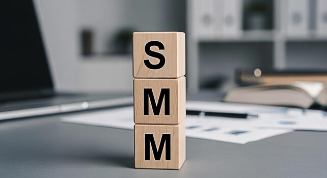 Wooden blocks displaying SMM in a modern office setting symbolizing social media marketing strategies and solutions for business growth and online presence conveying a message of innovation and succes photo
