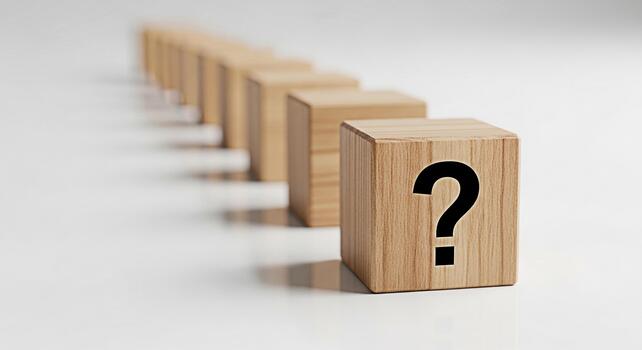 Wooden blocks displaying a question mark in a conceptual arrangement on a white surface representing uncertainty problemsolving and the search for answers in a clean minimalist setting photo