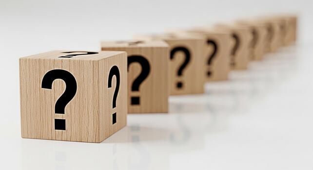 Row of wooden blocks displaying question marks on a white surface representing uncertainty and the need for answers in a clean minimalist environment creating a sense of mystery and intellectual curio photo