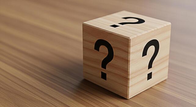 Wooden cube displaying question marks on a wooden surface symbolizing uncertainty and curiosity inviting viewers to ponder solutions and explore possibilities in a conceptual and thoughtprovoking sett photo