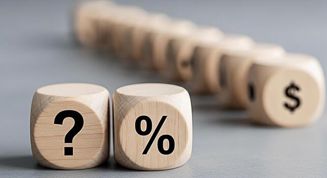 Wooden dice displaying a question mark and percentage symbol on a gray surface representing financial uncertainty and interest rates with a dollar sign in the background creating a sense of economic a photo