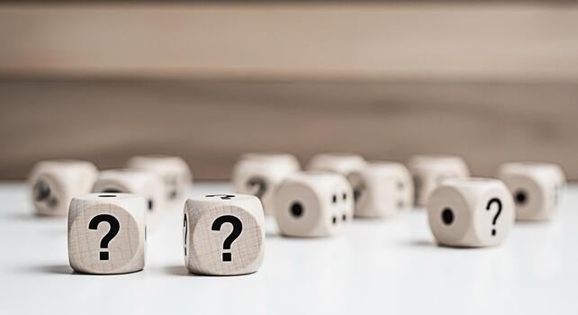 Wooden dice displaying question marks on a white surface representing uncertainty and the need for answers in a clean minimalist environment creating a sense of curiosity and problemsolving photo