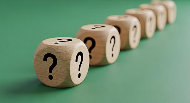 Wooden dice displaying question marks in a row on a green surface representing uncertainty questioning and the need for answers in a business or educational context creating a thoughtful and inquisiti photo