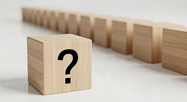 Wooden cube displaying a question mark standing out from a row of similar cubes on a white surface symbolizing uncertainty problemsolving and the search for answers in a minimalist setting photo