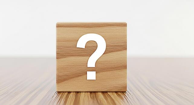 Wooden block displaying a question mark on a wooden surface symbolizing uncertainty and the need for answers in a minimalist and clean environment perfect for concepts related to problemsolving photo