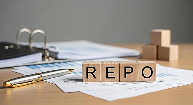 Wooden blocks spelling REPO on a desk with financial reports and a pen representing repurchase agreements in a professional setting conveying a sense of financial analysis and market operations photo