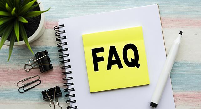 FAQ message displayed on a yellow sticky note attached to a spiral notebook placed on a wooden desk with a pen and plant symbolizing information and customer support in a bright and organized workspac photo