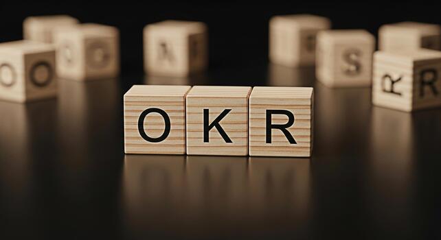 Wooden blocks displaying OKR acronym on a dark surface representing Objectives and Key Results in a business setting conveying a sense of strategic planning and goaloriented mindset for success photo