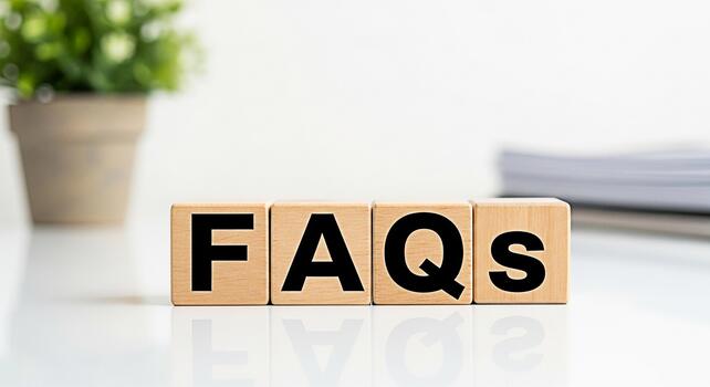 Wooden blocks spelling FAQs on a white table in a bright office setting representing information support and frequently asked questions for customer service and online assistance photo