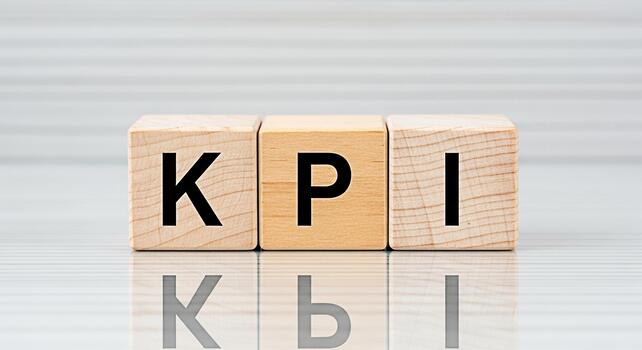 Wooden blocks displaying KPI on a reflective surface in a bright studio symbolizing key performance indicators and business metrics for performance measurement and strategic business success photo