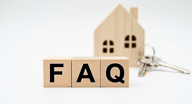 Wooden blocks spelling FAQ with a miniature house and keys on a white background representing frequently asked questions about real estate mortgages and homeownership with a clean and informative mood photo