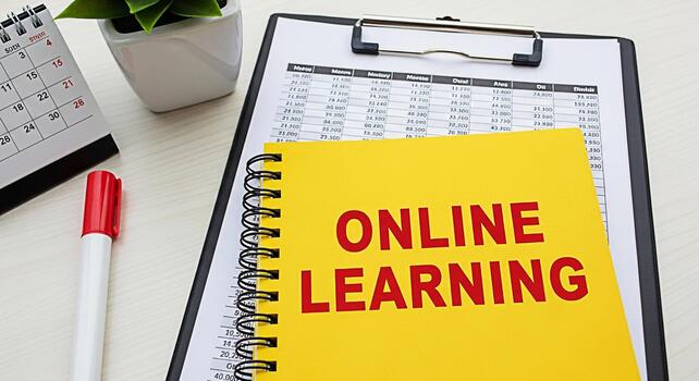 Closeup of a yellow notebook displaying Online Learning on a bright desk with a calendar marker and financial documents creating a focused and educational atmosphere for remote studies photo