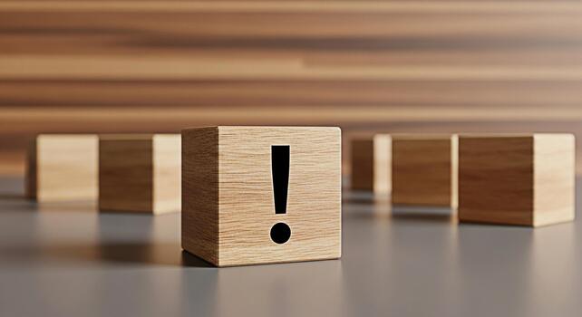 Wooden block displaying an exclamation mark standing out among other blocks on a smooth surface against a wooden background symbolizing warning attention and the importance of problemsolving photo